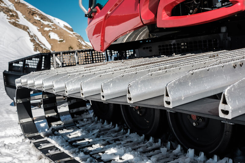 Snow grooming machine Ratrak. Winter mountain landscape